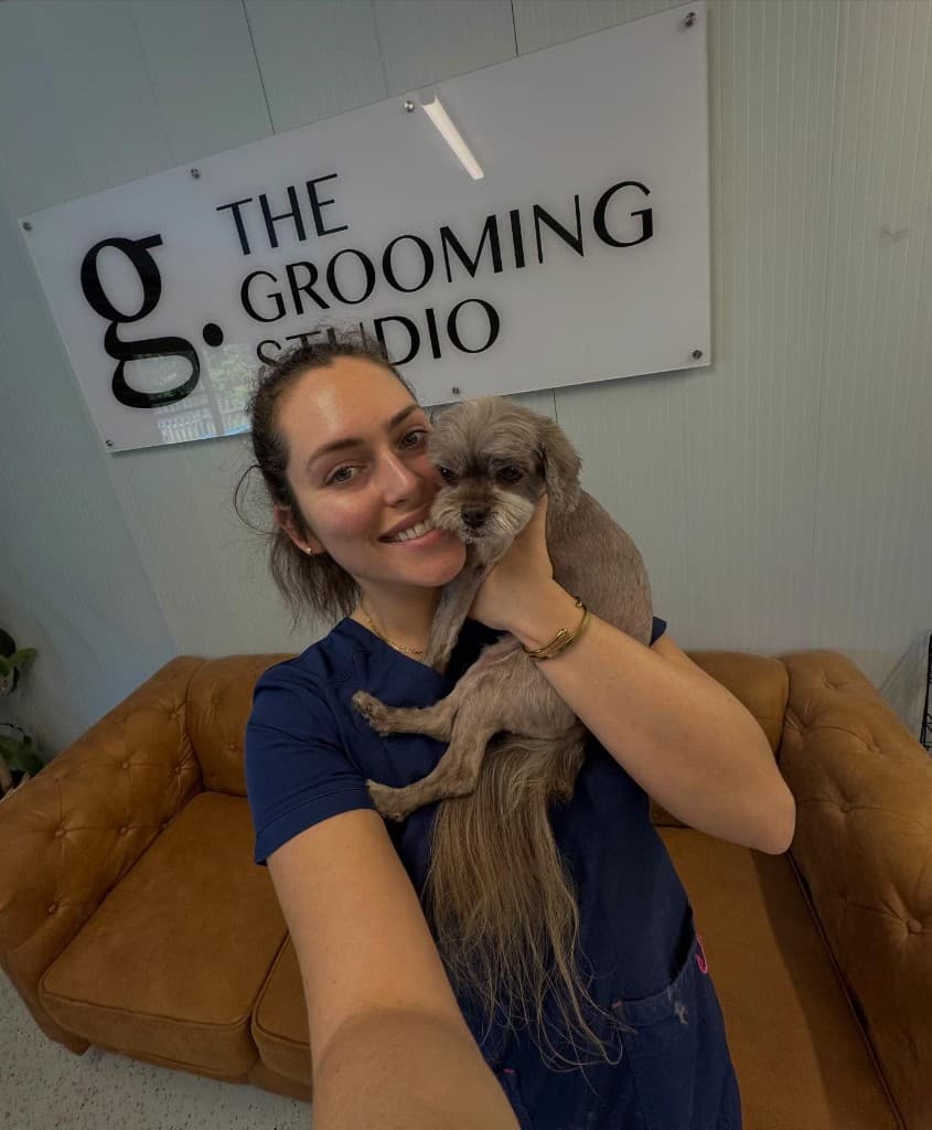 Shannon with a happy pup at The Grooming Studio — professional care in a warm, friendly space